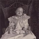 Young girl in wicker chair